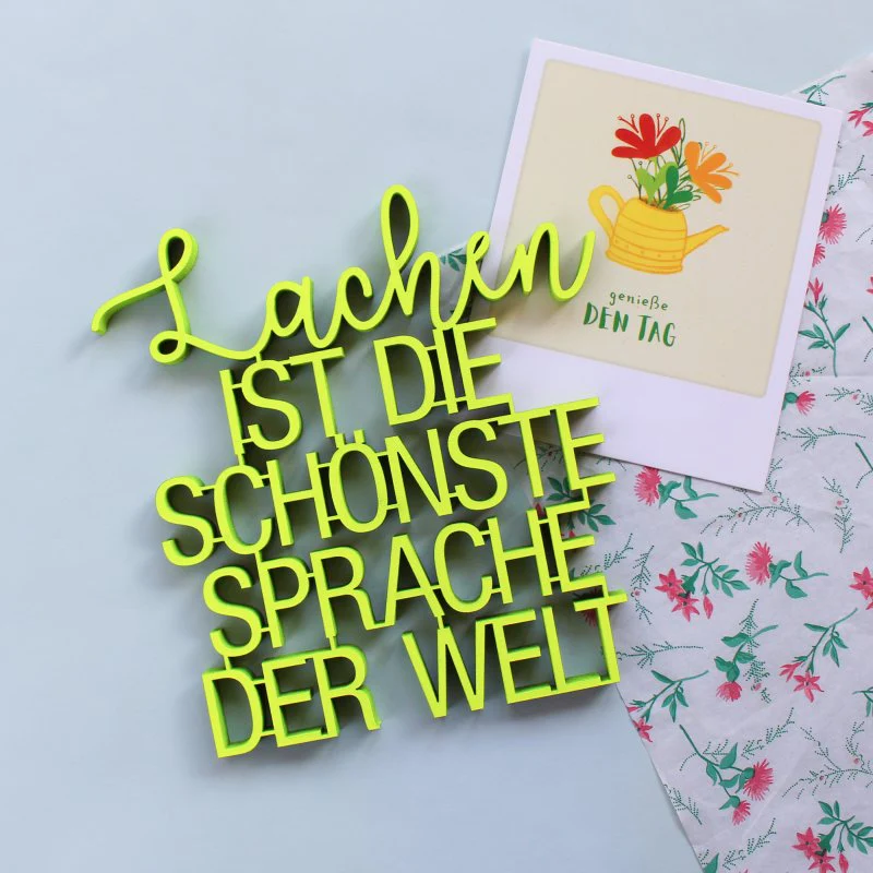 Lachen ist die schönste Sprache der Welt - neongelber 3D Schriftzug